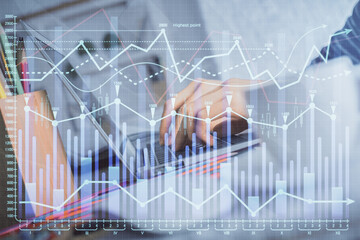 Double exposure of woman hands typing on computer and forex chart hologram drawing. Stock market invest concept.