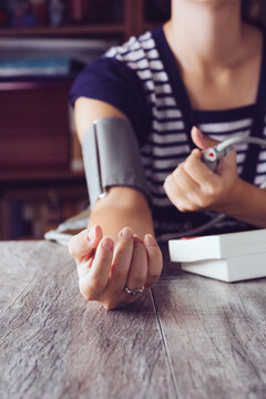 Woman measuring her blood pressure