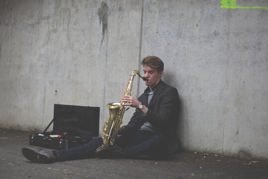 Young tenor saxophonist in an urban tunnel