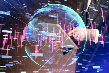 Fototapeta premium Double exposure of man's hands holding and using a digital device and forex graph drawing. Financial market concept.