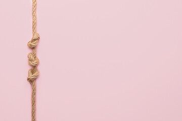 Rope with knots on color background