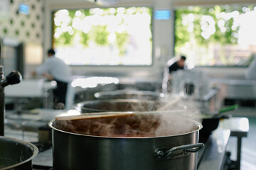 Close up of a saucepan in a big modern kitchen