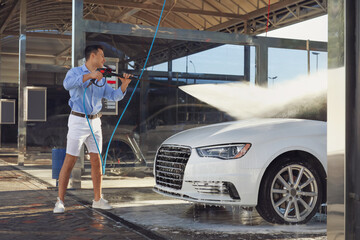 Man washing his car outdoors