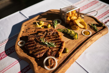t-bone steak on wooden plate