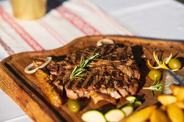 t-bone steak on wooden plate