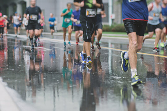 Legs and feet of joggers, running a marathon