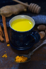 Turmeric golden milk in a small blue cup
