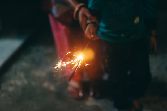 Toddler and her mother holding sparkler