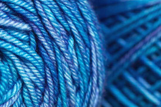 Macro of variegated blue spool of yarn