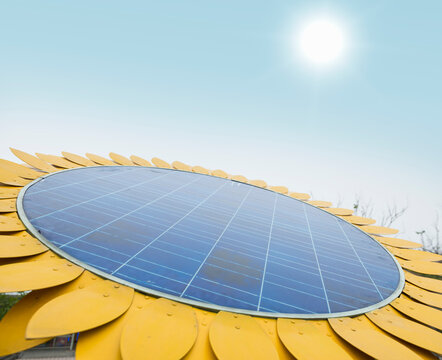 Solar panel with sunflower shape under sky and sun