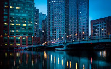 Futuristic image of Boston Financial District over the Boston Harbor at twilight