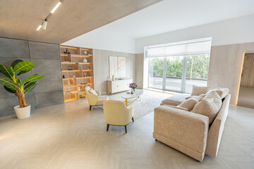 Fototapeta na wymiar modern interior design of the living area in the studio apartment in warm soft colors. decorative built-in lighting and soft beige furniture