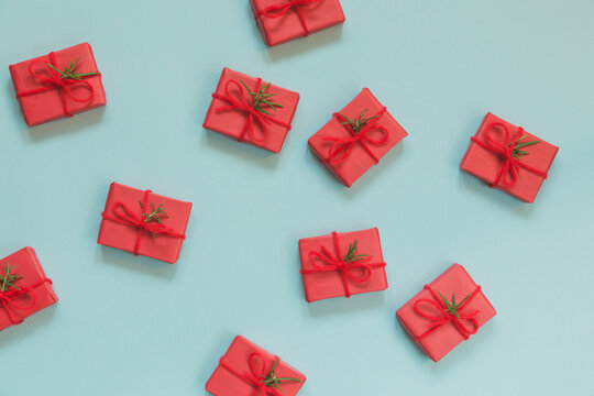 Horizontal - small red Christmas gifts scattered on a blue background
