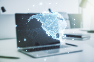 Digital America map on modern laptop background, international trading concept. Multiexposure