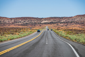 Fototapeta na wymiar Asphalt road in USA. Empty asphalt highway and blue sky. Long Desert Highway California.