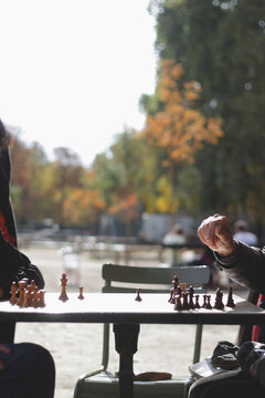 Hand hovering over a game of chess