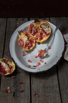 Pomegranate on a rustic ceramic plate