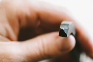 Jewellery designer stamping 14K symbol onto wedding ring