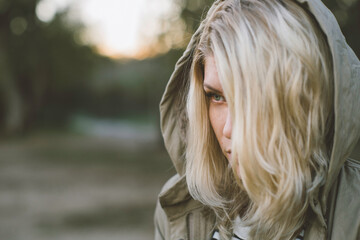 Young blonde woman with a hoodie.