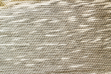 Hand-woven rug in gray and white tones,background