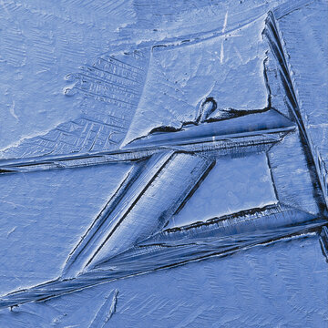closeup telephoto of a large blue crystal of ice formed in a river in winter