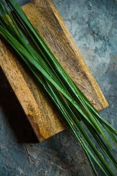 Fresh lemongrass or citronella grass on rustic wooden board. Herb used for healthy eating.