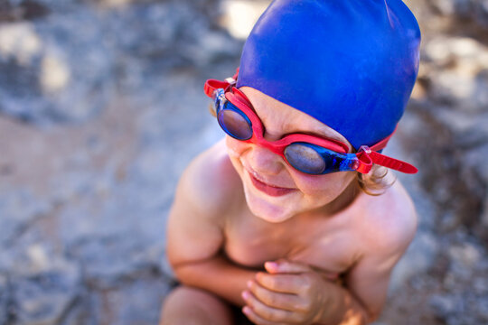 Excited Little Boy With Blue Swim Cap and Goggles