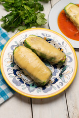 Stuffed zucchini with tuna and melted cheese on white background