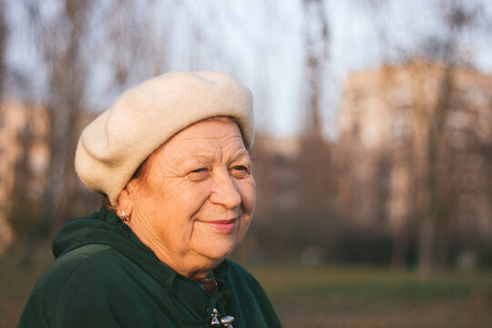 Senior woman portrait in the park on the sunset