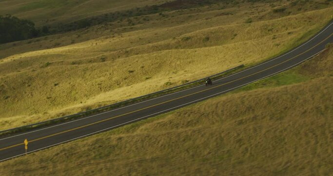 Aerial view of man riding a motorcycle on a country road