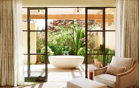 Luxury hotel room with outdoor bathtub on patio