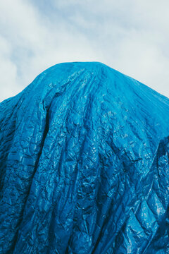 Blue tarpaulin covering pile of commercial fishing equipment