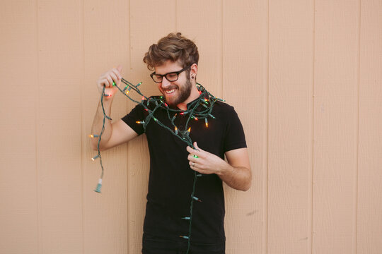Young Man Hanging Christmas Lights