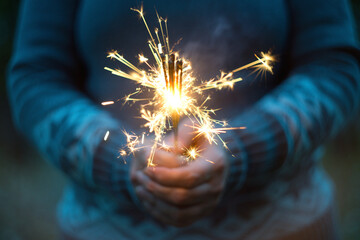 Female hands holding sparkler