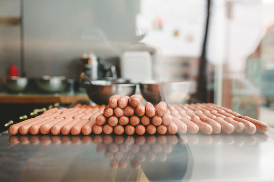 Rows and stacks of uncooked hotdogs