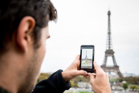 Man Taking Mobile Phone Photo of Eiffel Tower Paris from The The TrocadÔøΩÔøΩro