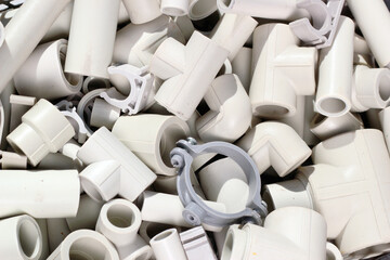 Parts of plastic piping and fitting as plumbing background.