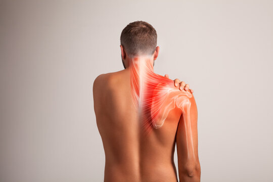 Shoulder scapula pain, man holding a hand on a painful zone	
