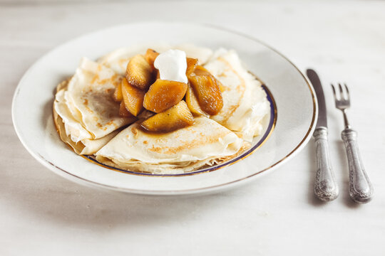 Thin pancakes with apples and cream