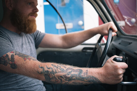 Young man is switching gears in old vintage car