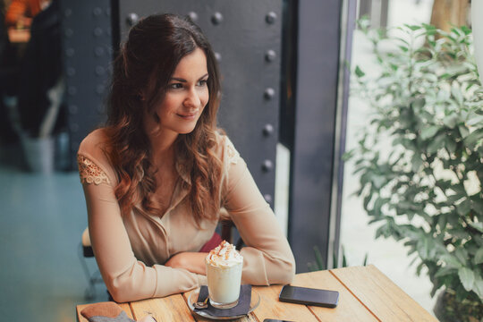 Beautiful Woman Sitting at a Coffee Shop