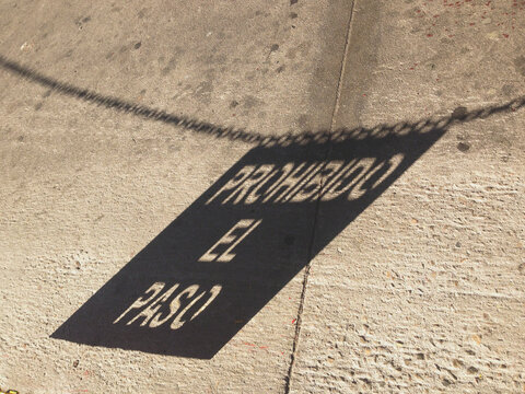 Shadow of closed road sign