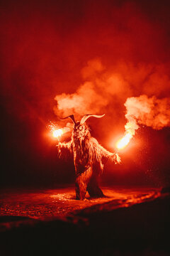 helper to St. Nicholas with bengal light standing in water