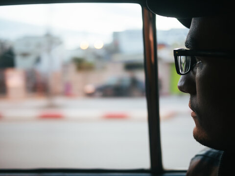 Portrait of man looking out of car window
