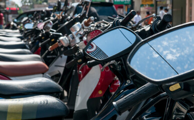 Dozens of motor bikes pared in a line