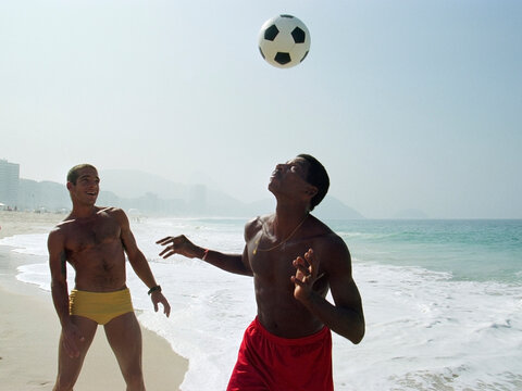 Two men playing soccer on Ipanema beach. Rio de Janeiro. Brazil