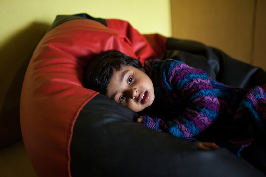 Toddler resting on a air bag sofa