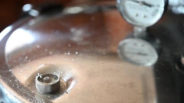 Pressure cooker building up steam and bubbling out unsealed valve