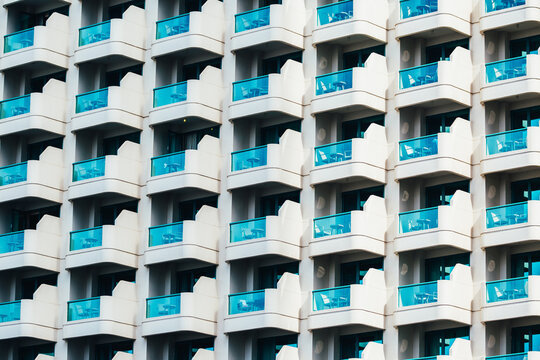 Pattern of blue balconies on a building of apartments next to the beach. Dubai Marina, United Arab Emirates