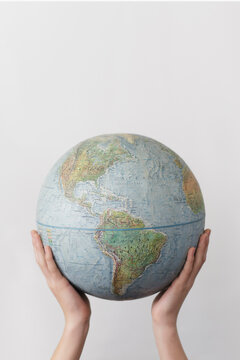 Globe held by two hands